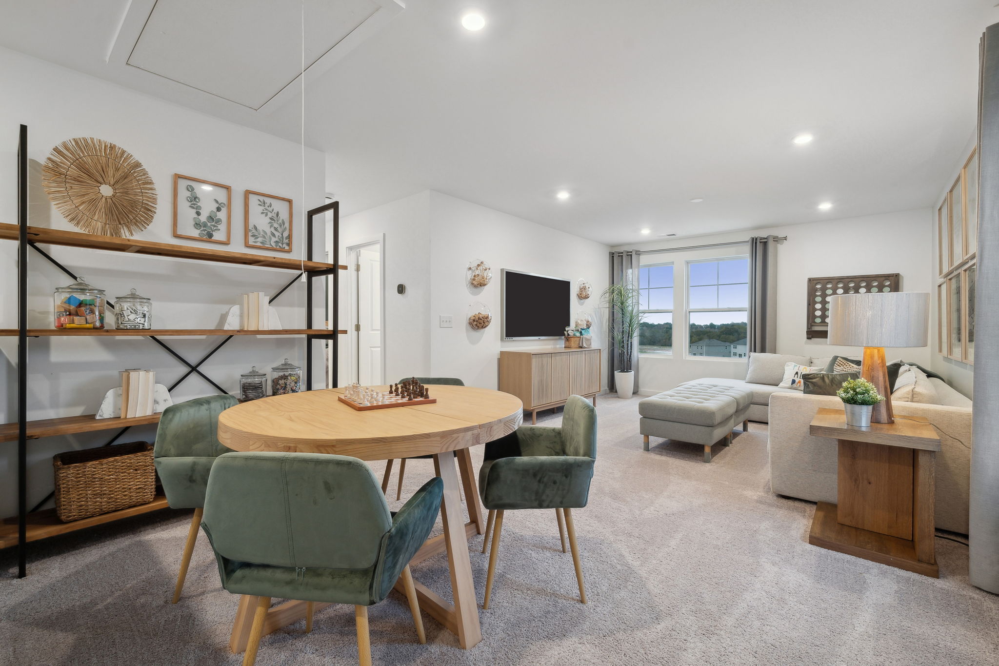 A living room with a table and chairs.