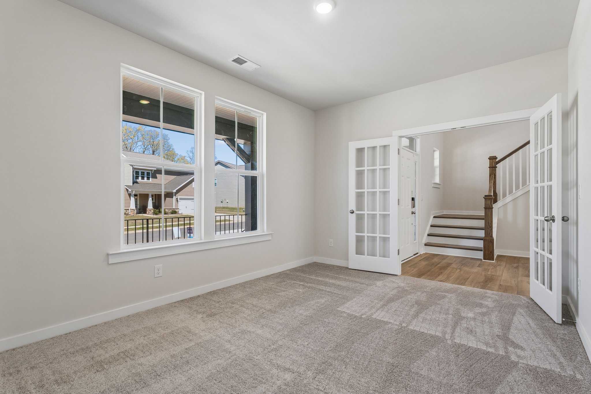 A room with a staircase and a window.
