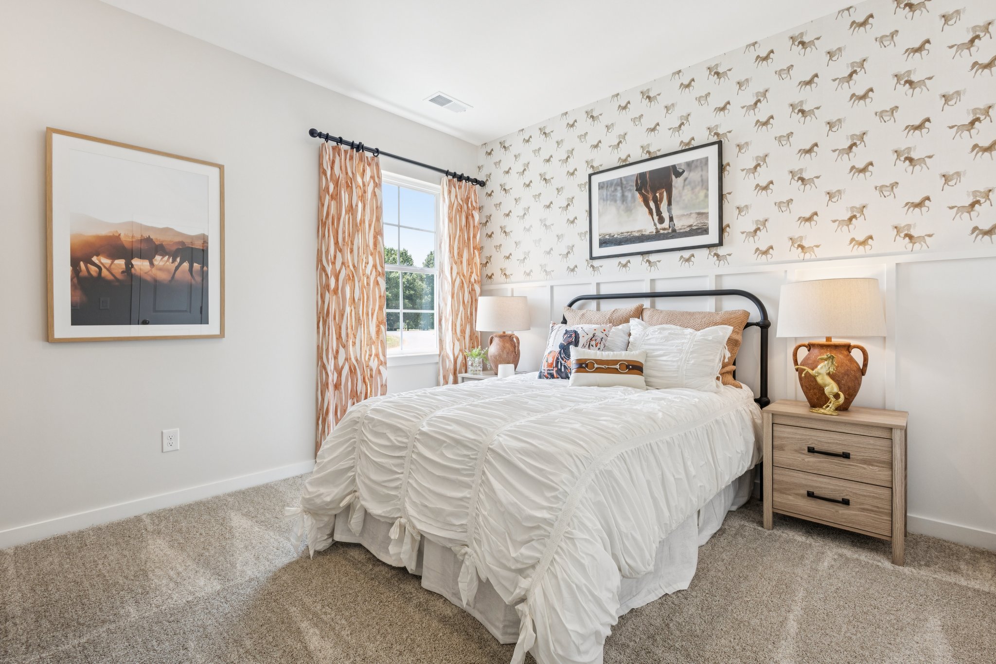 A bedroom with a bed and lamps.