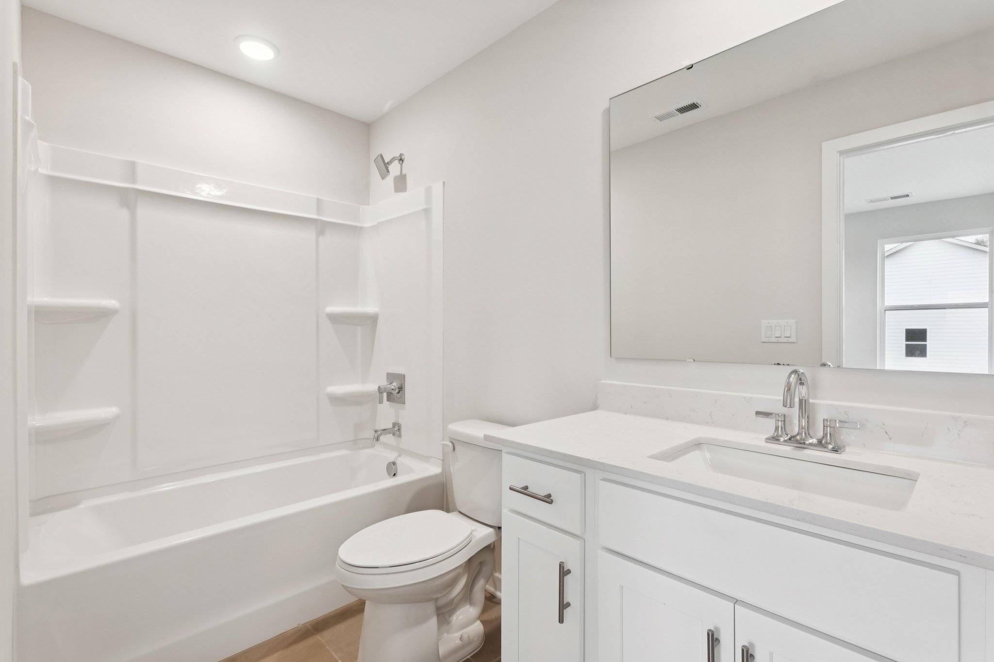 A bathroom with a tub sink and toilet.