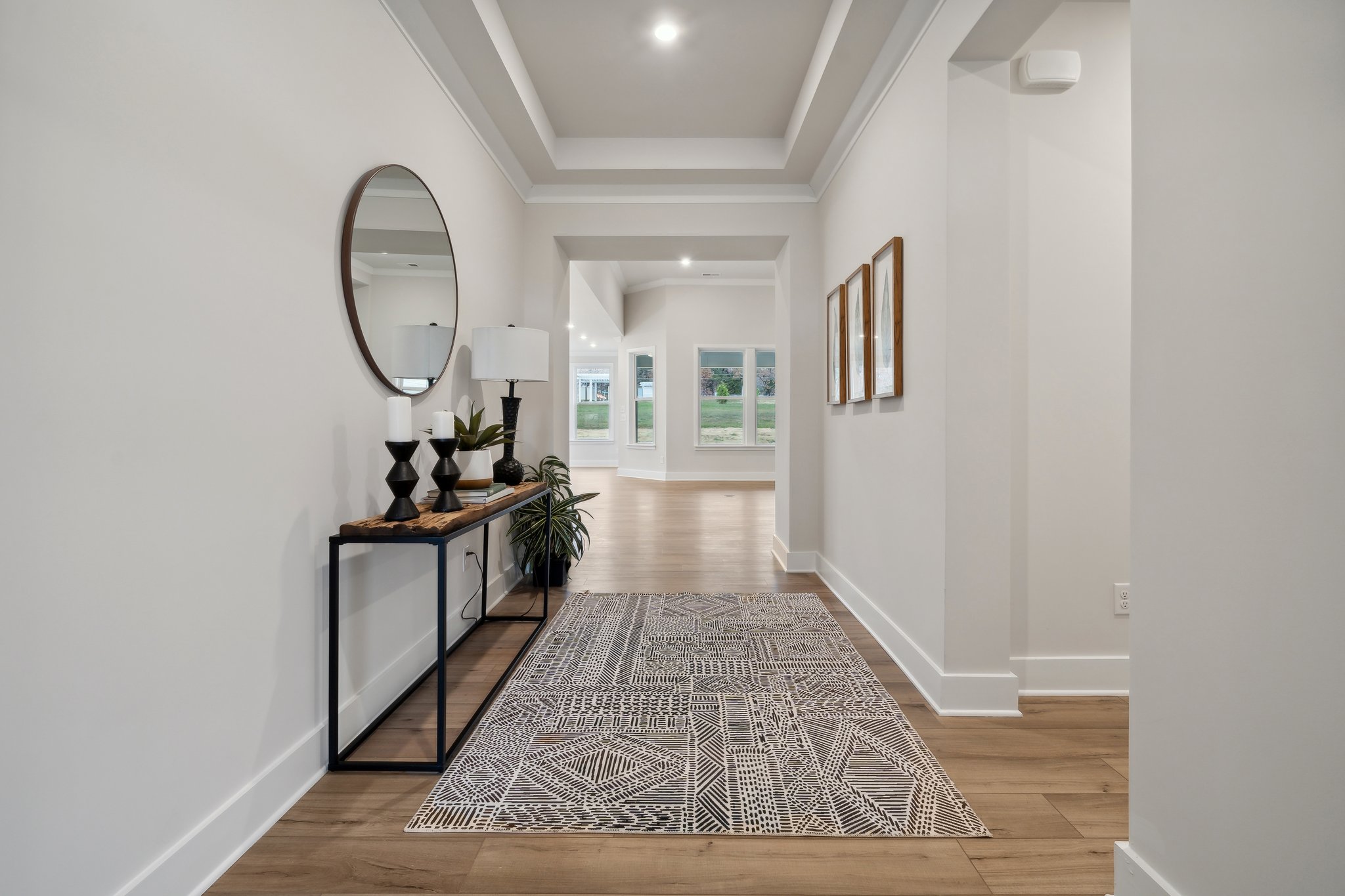 A room with a rug and a mirror.