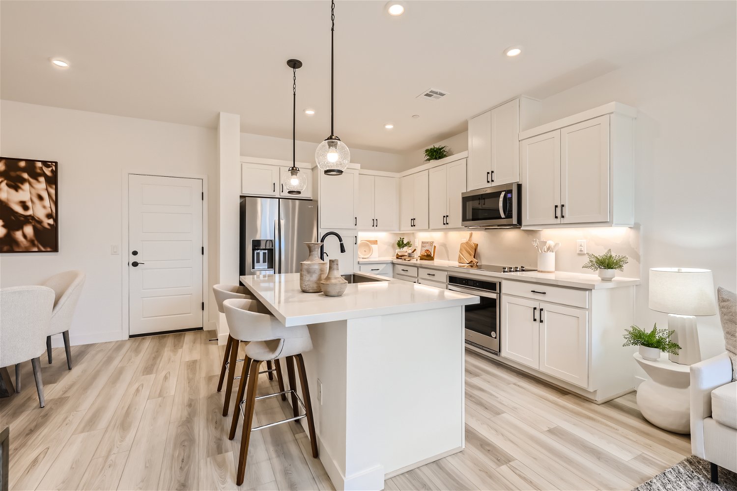 A kitchen with white cabinets.