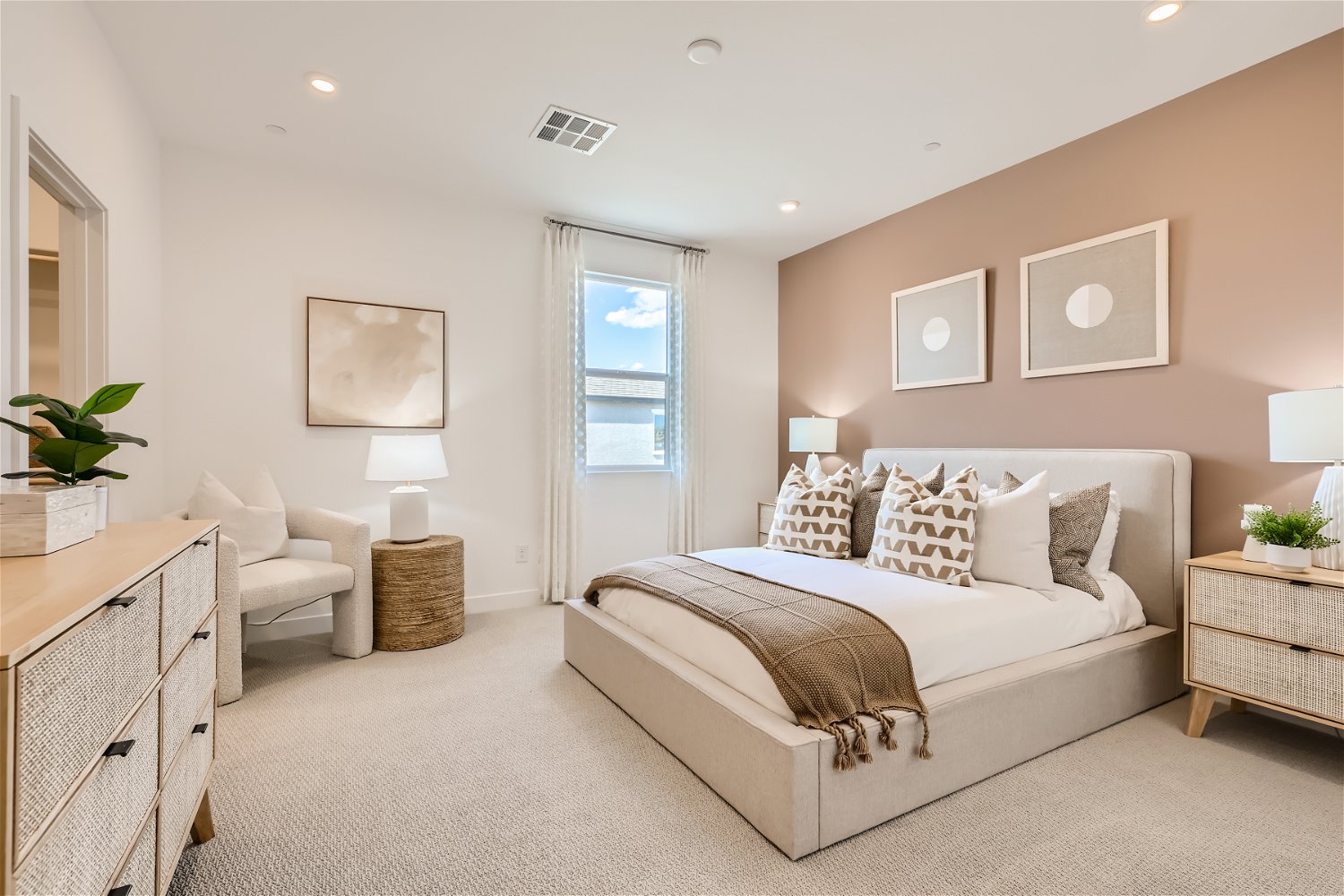 A bedroom with a bed and a chair.