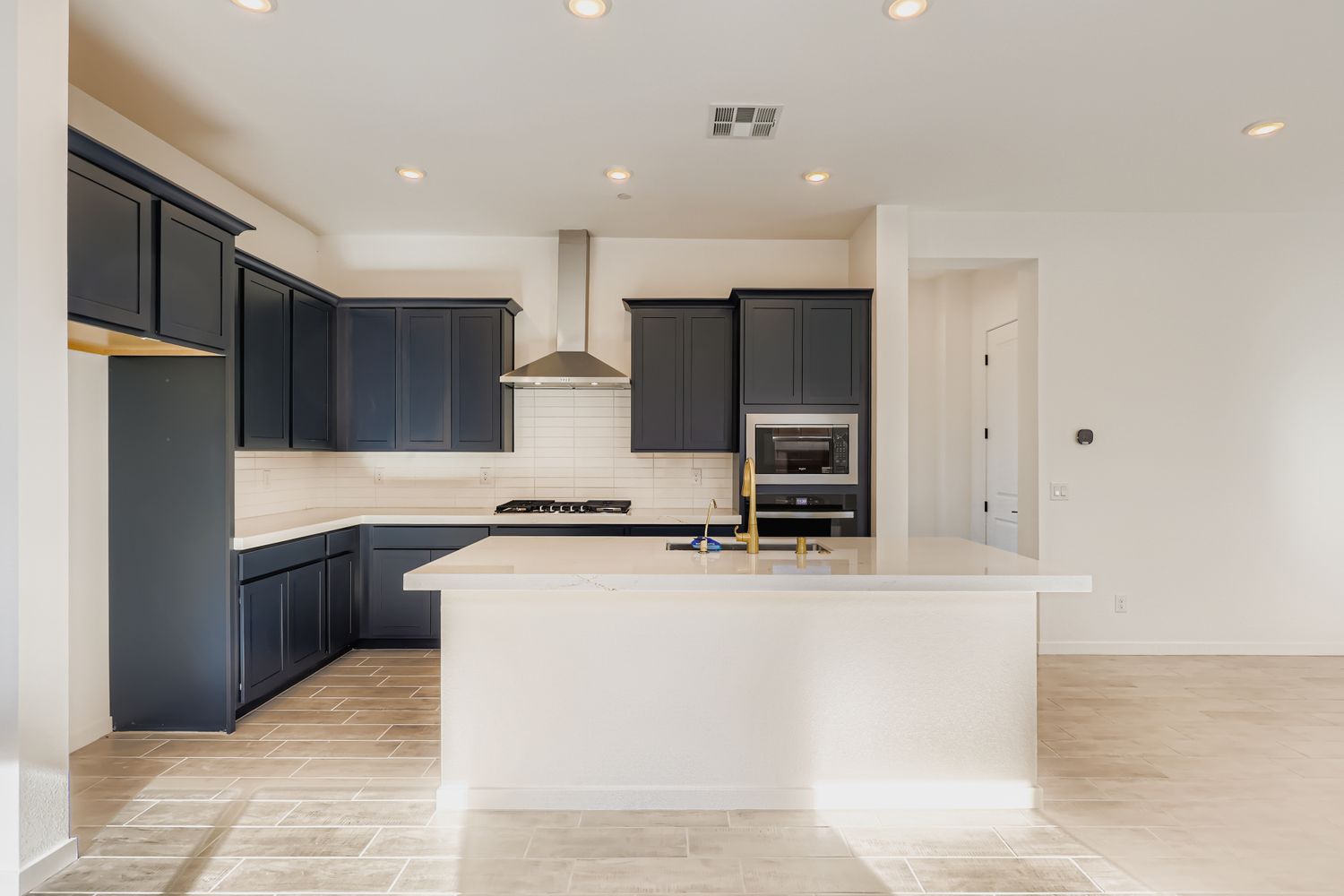 A kitchen with black cabinets.