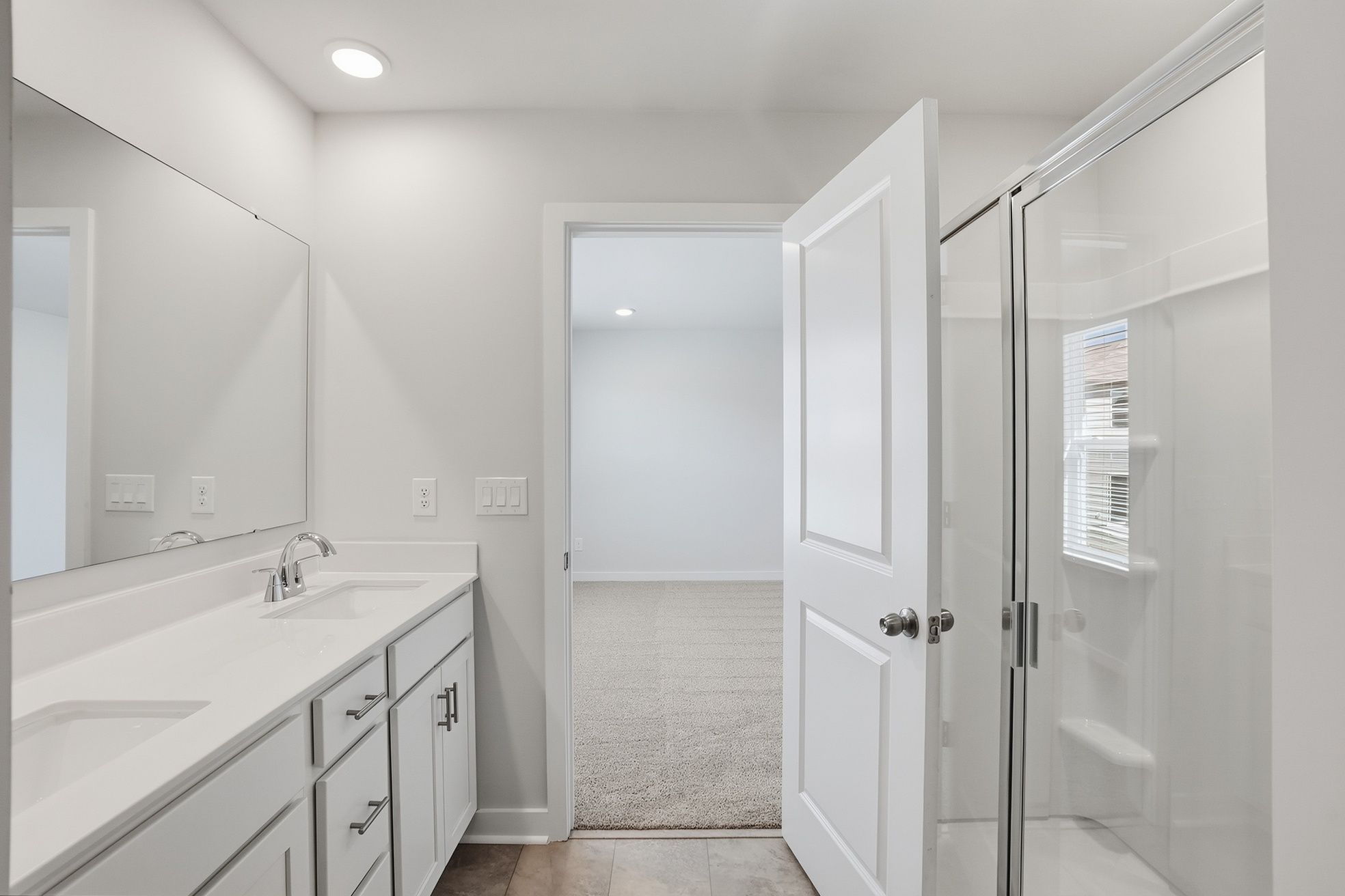A bathroom with a shower and sink.