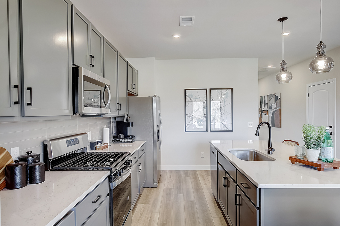 A kitchen with white cabinets.