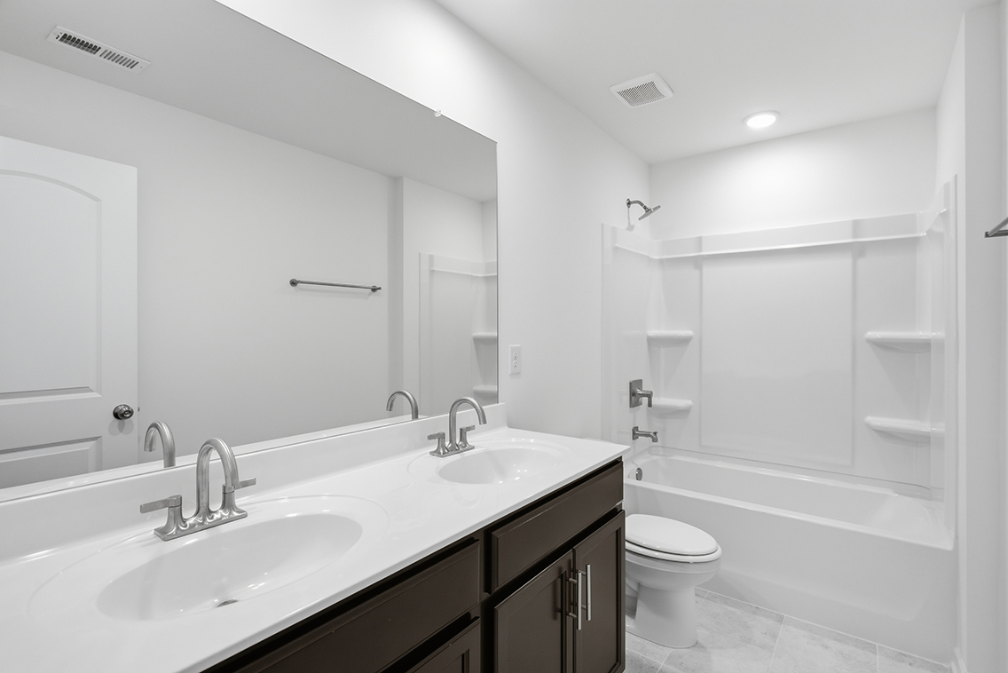 A bathroom with a large mirror.