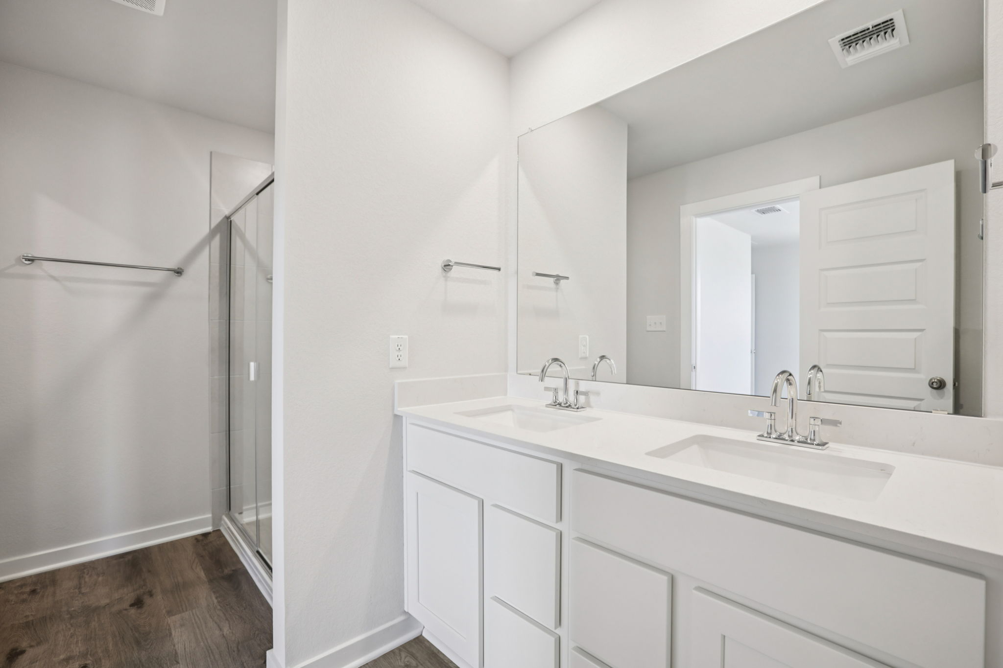 A bathroom with white cabinets.
