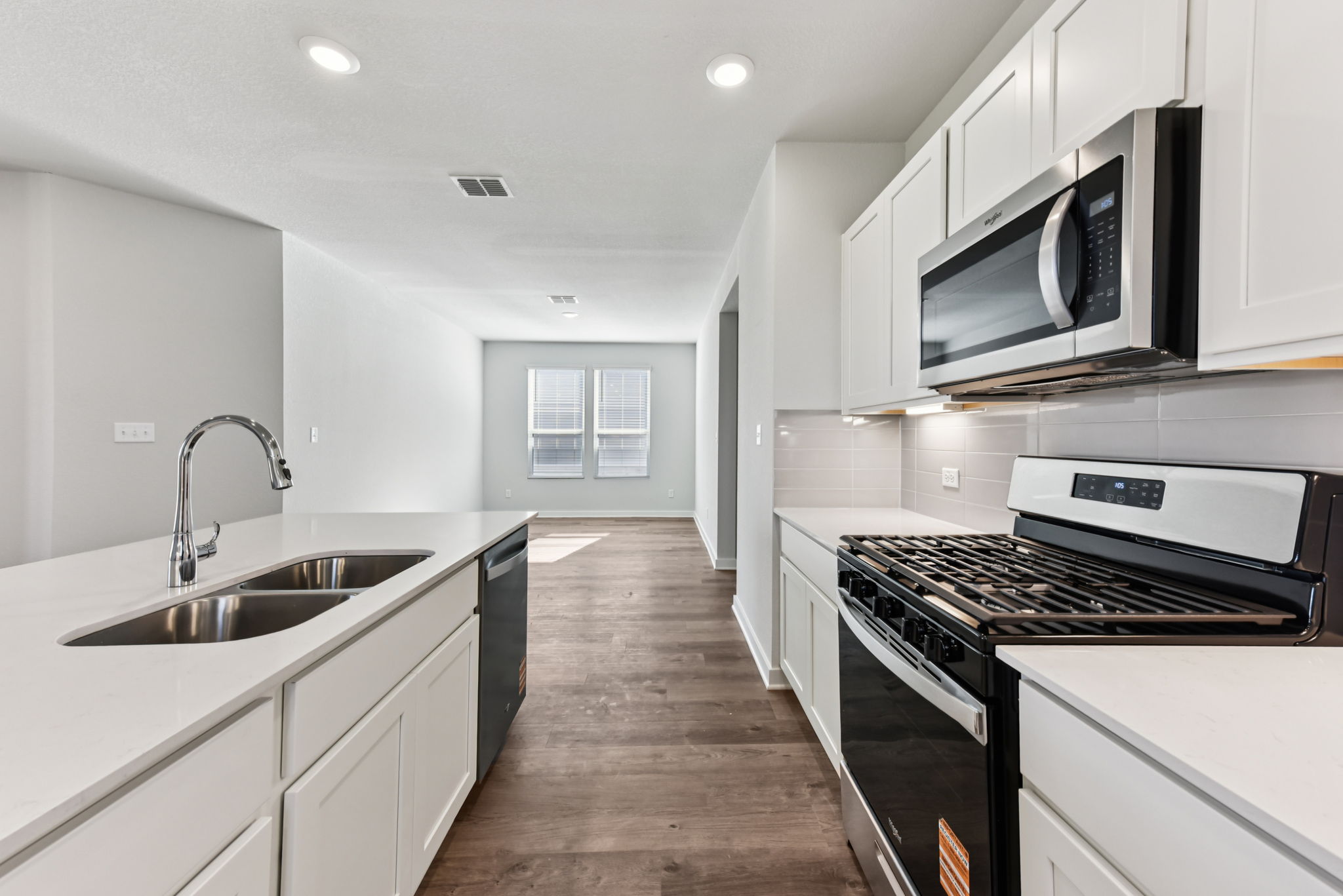 A kitchen with white cabinets.