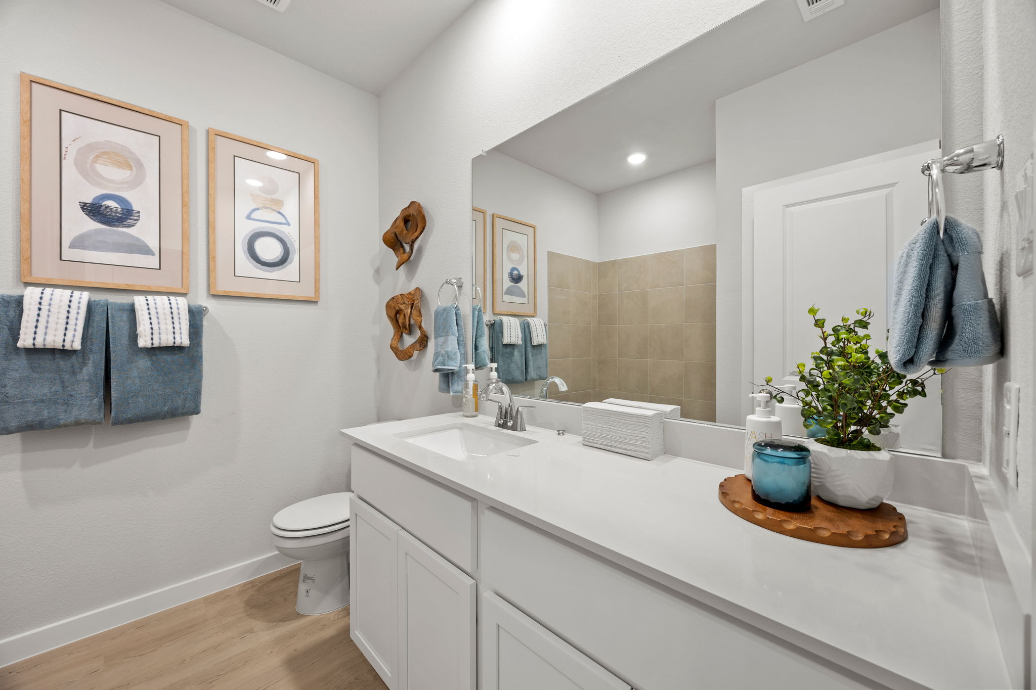 A bathroom with a large mirror.