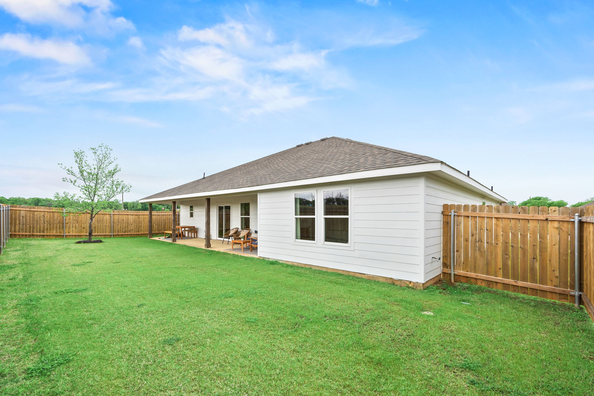 A house with a fence and grass.