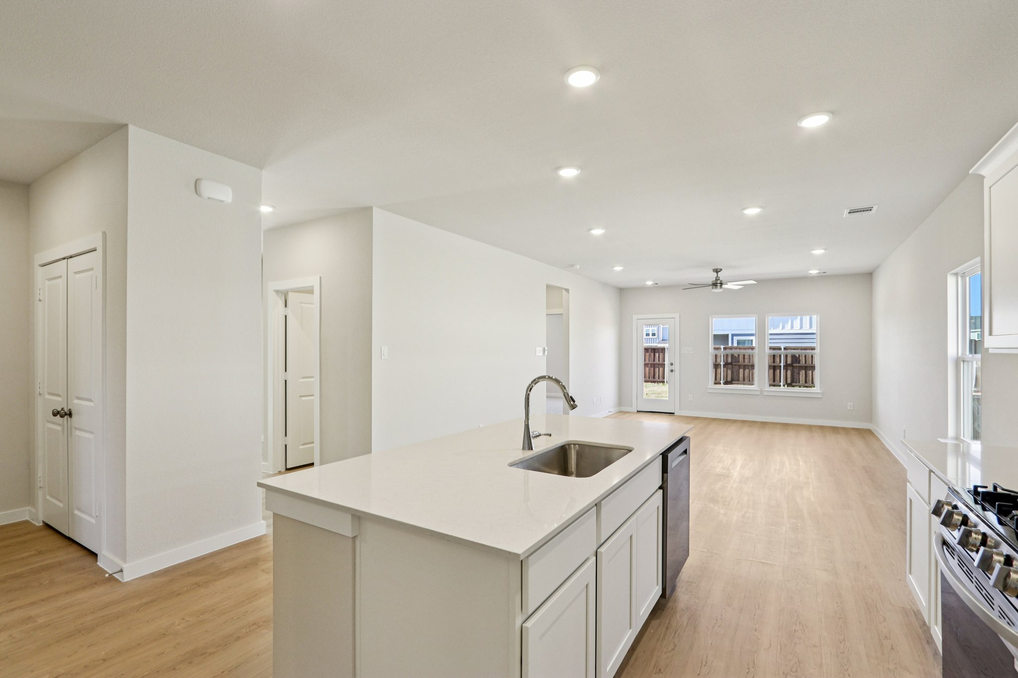 A kitchen with white cabinets.