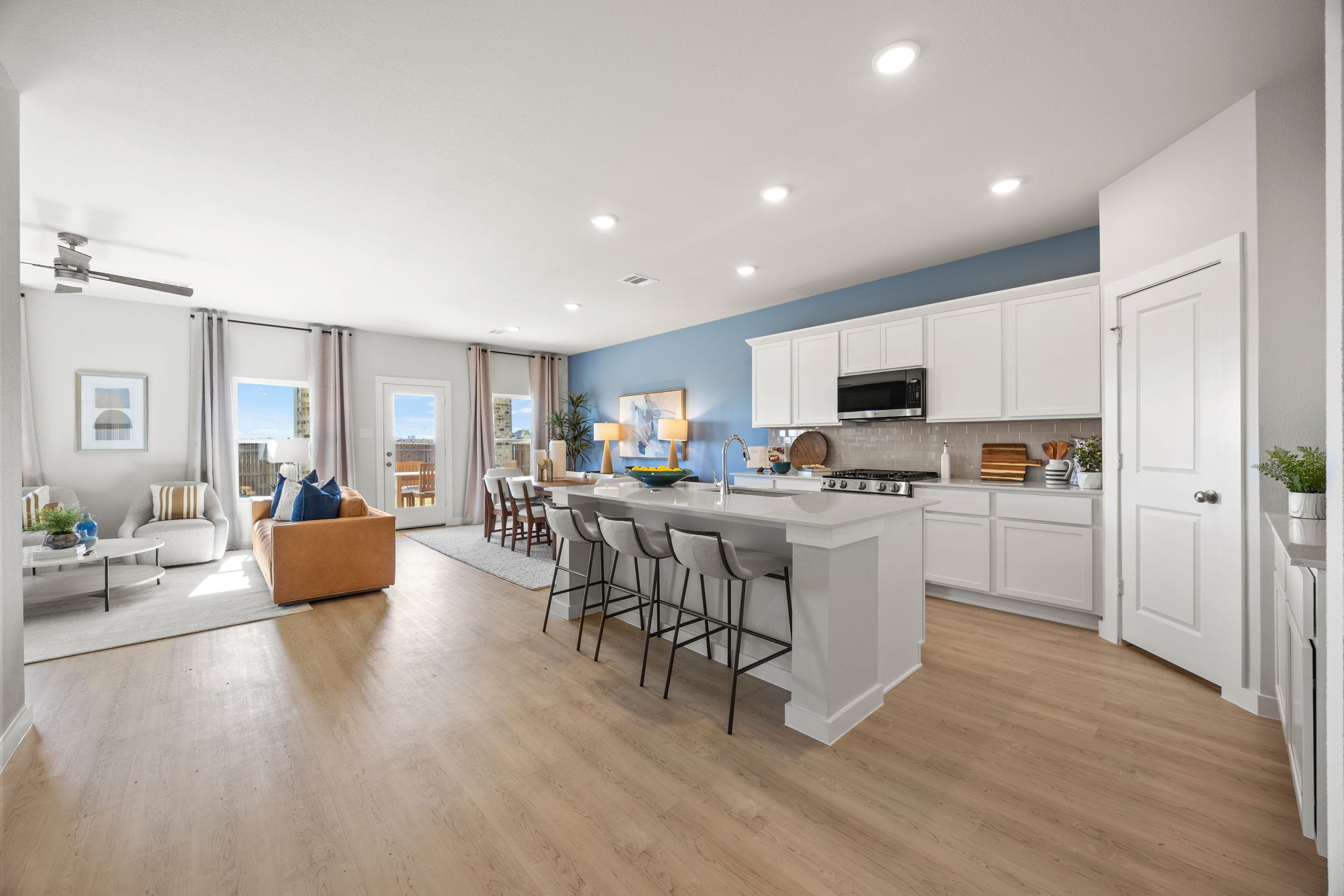 A kitchen with white cabinets.
