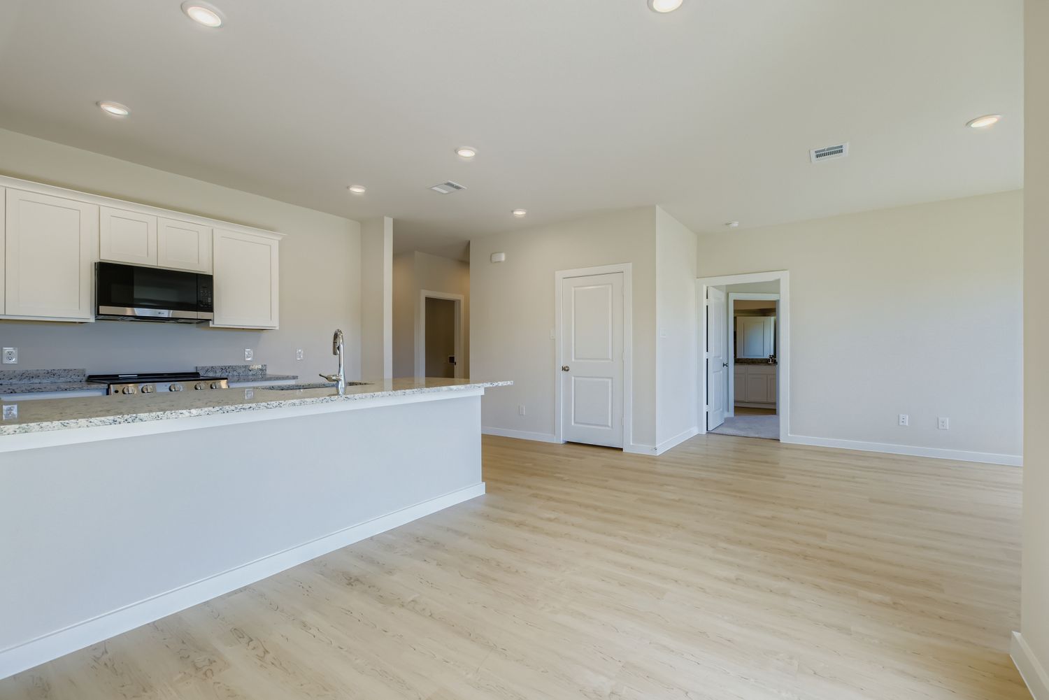 A kitchen with white cabinets.