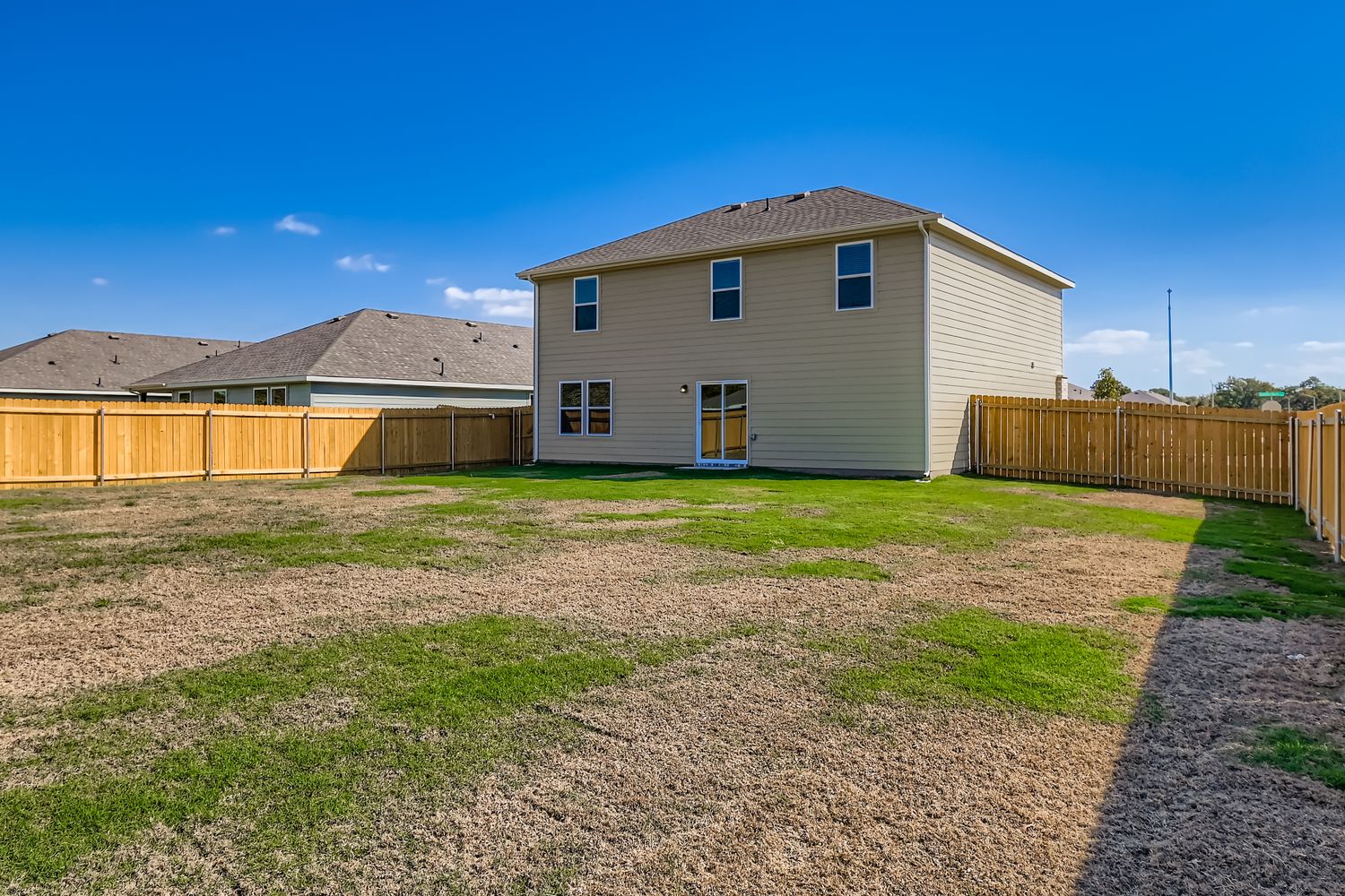A house with a dirt yard.