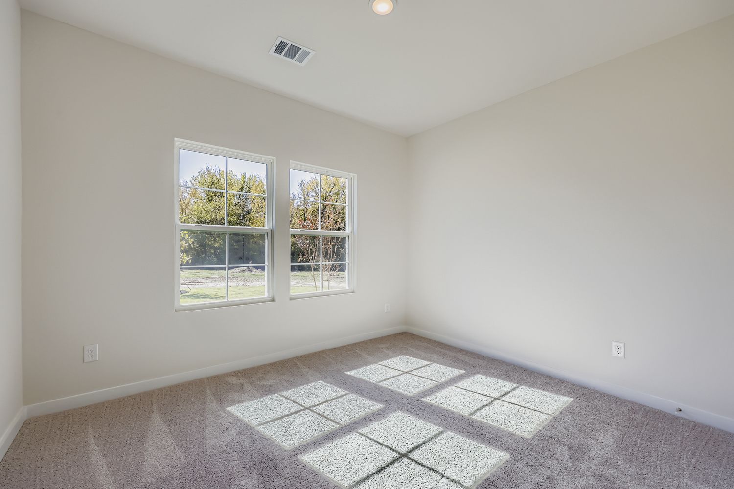 A room with windows and tile floor.