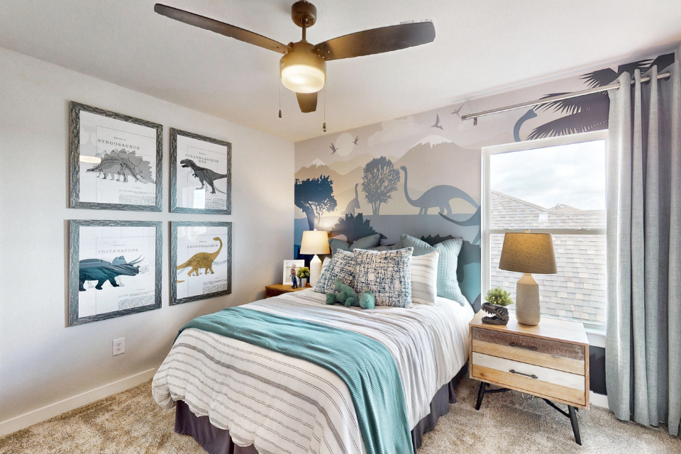 A bedroom with a bed and a table.