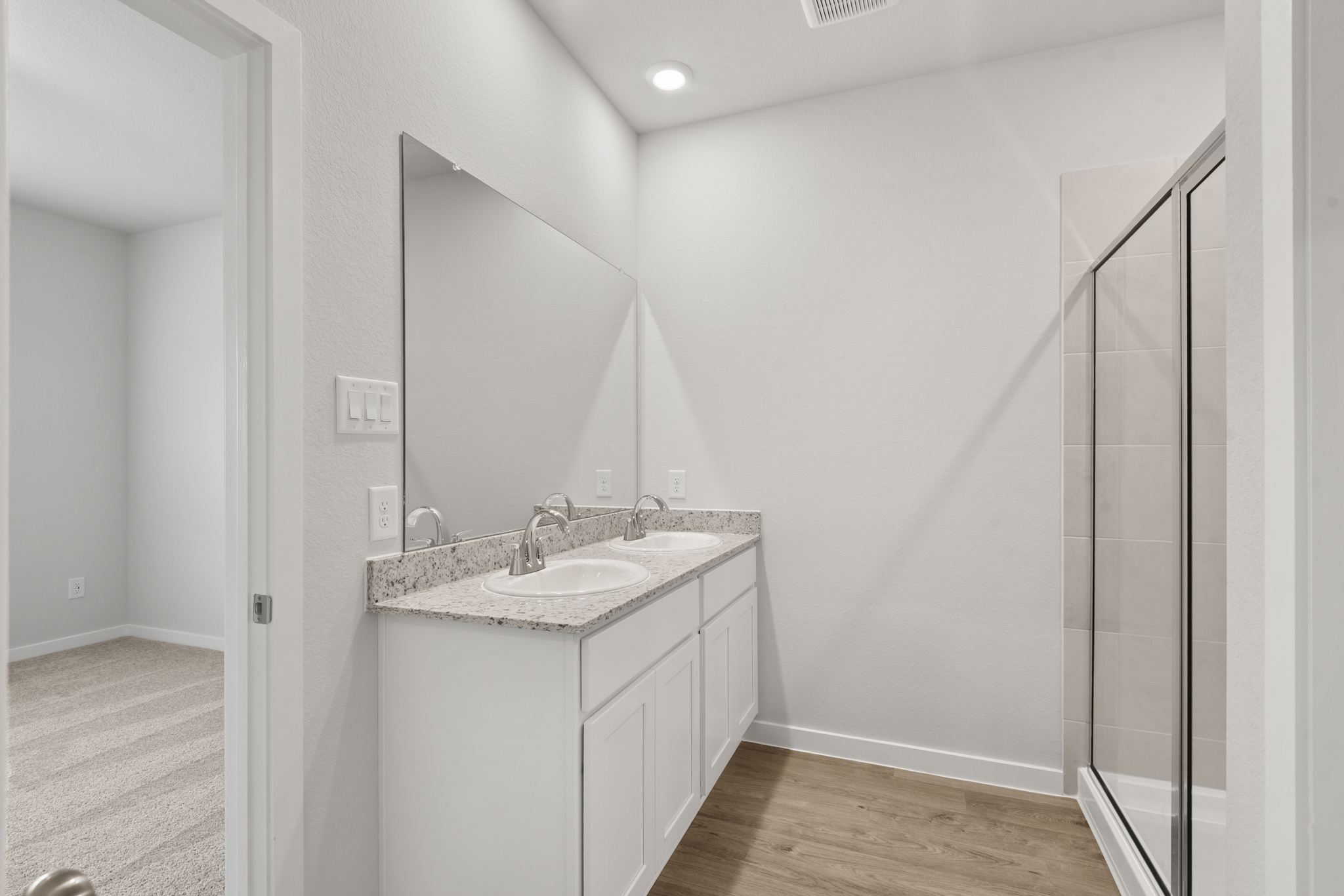 A bathroom with a sink and shower.
