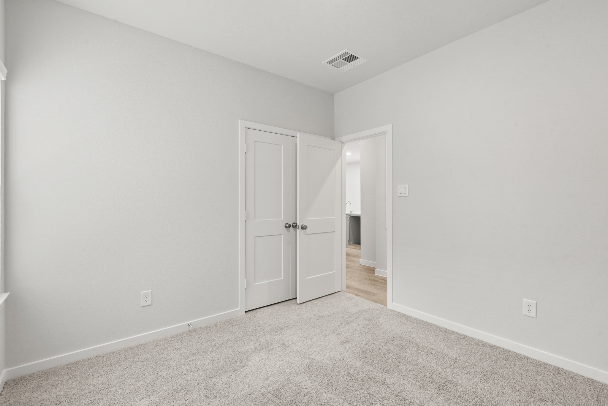 A hallway with white doors.