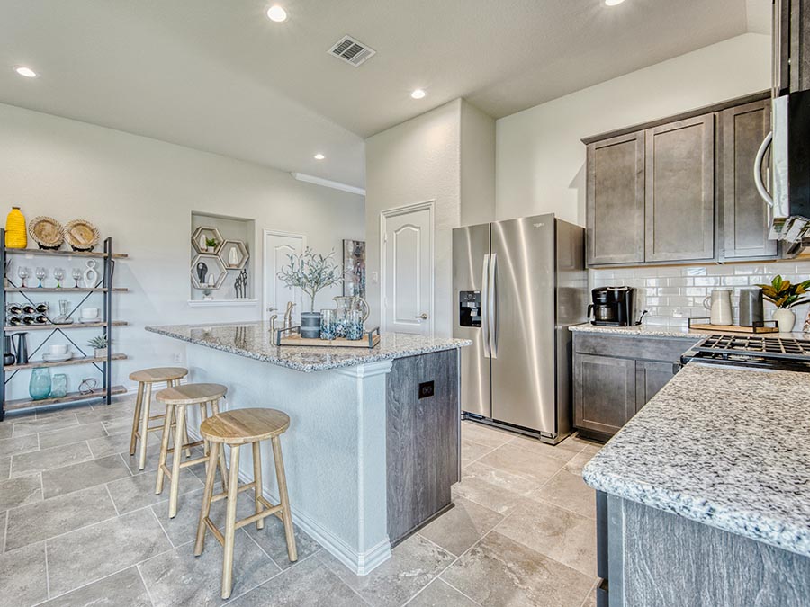 A kitchen with a bar stool.