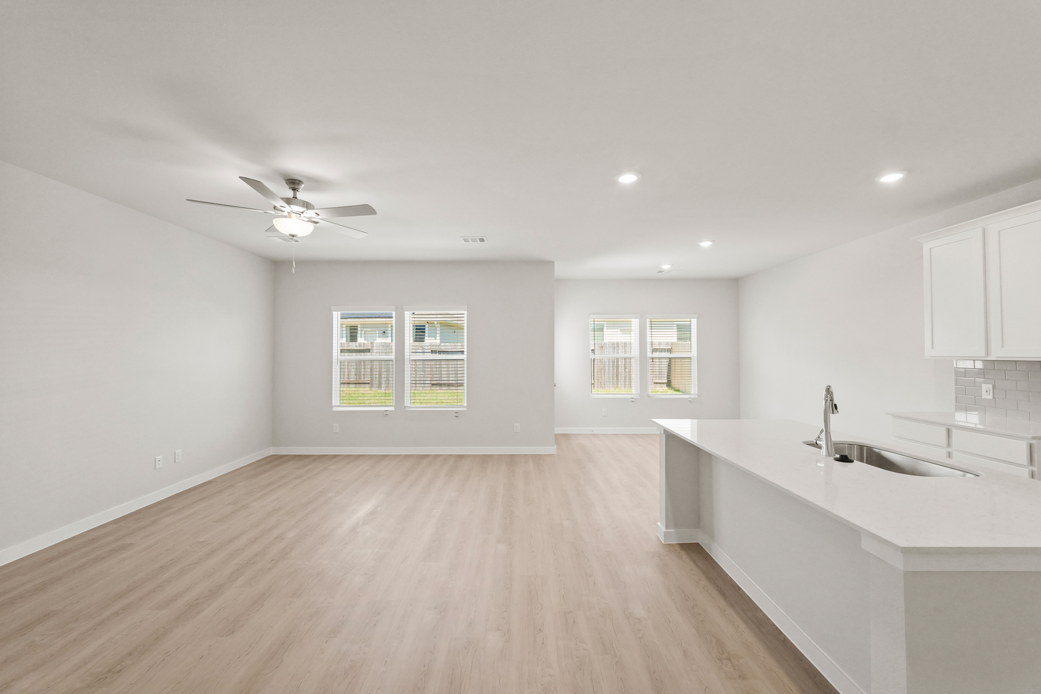 A large kitchen with a wood floor.