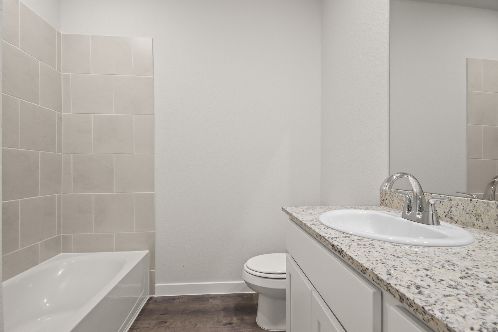 A bathroom with a sink toilet and bathtub.
