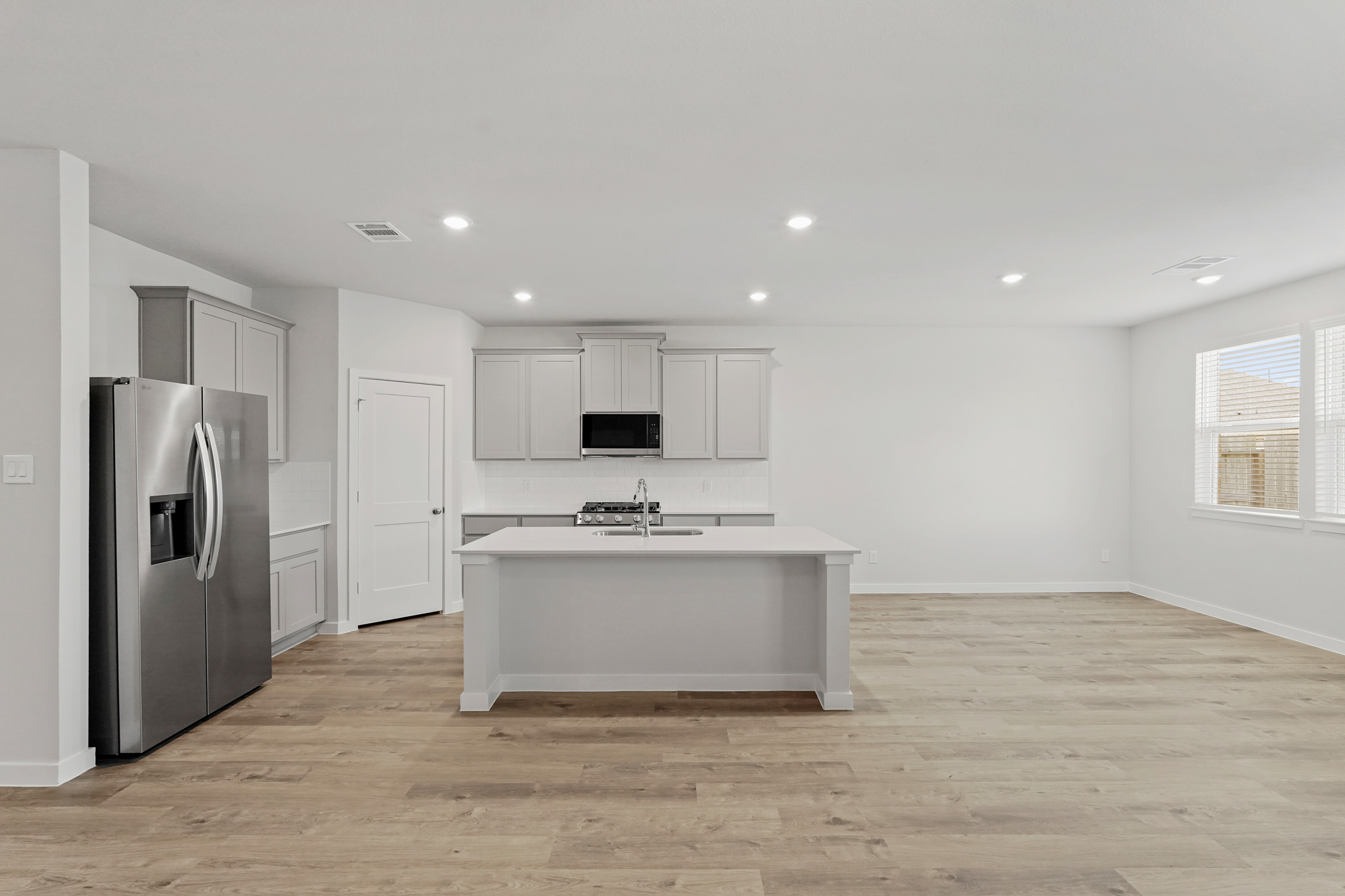 A kitchen with white cabinets.