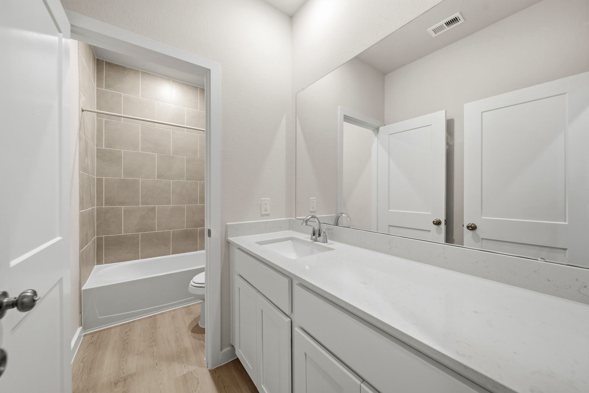 A bathroom with a tub sink and toilet.