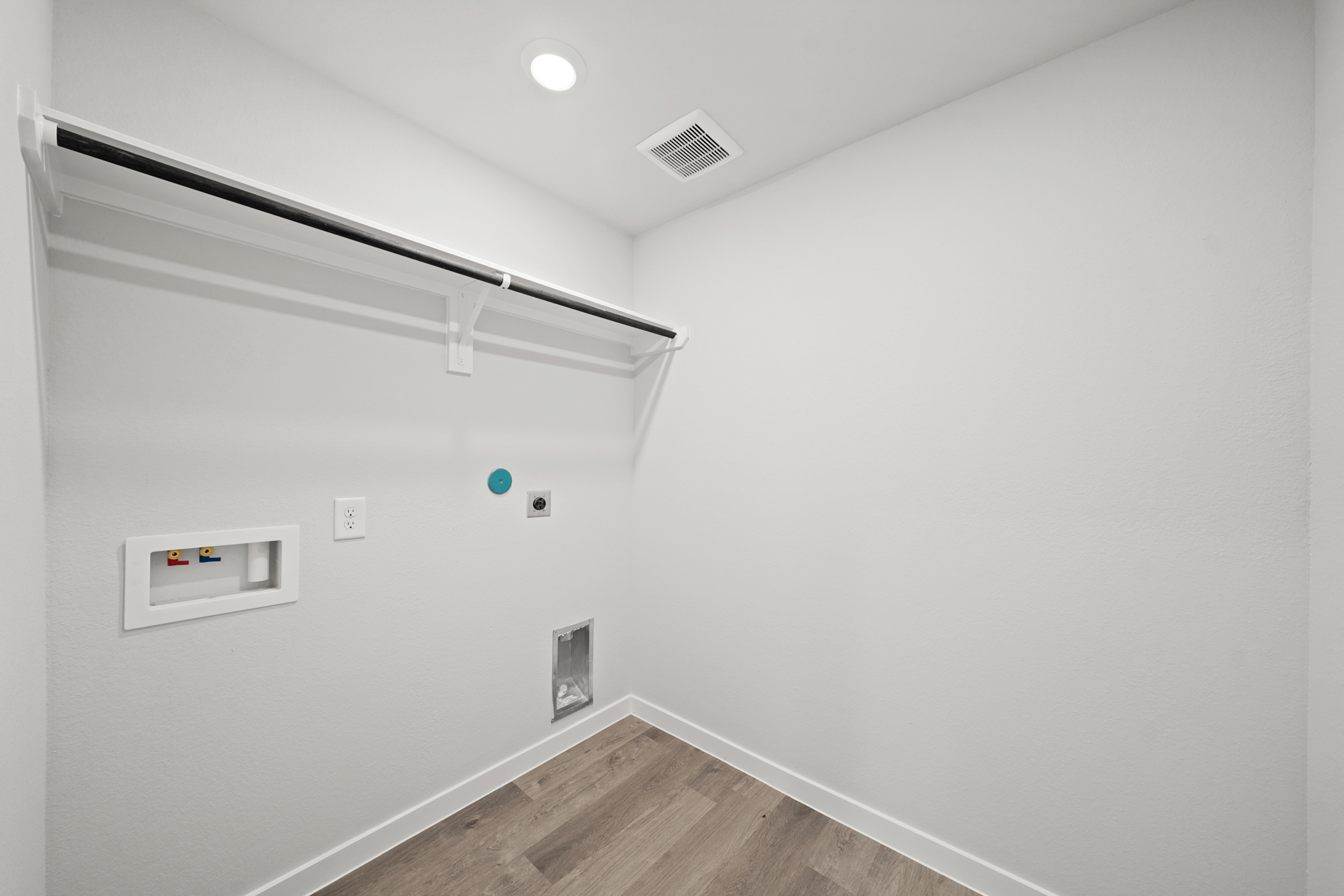 A white room with a wood floor.