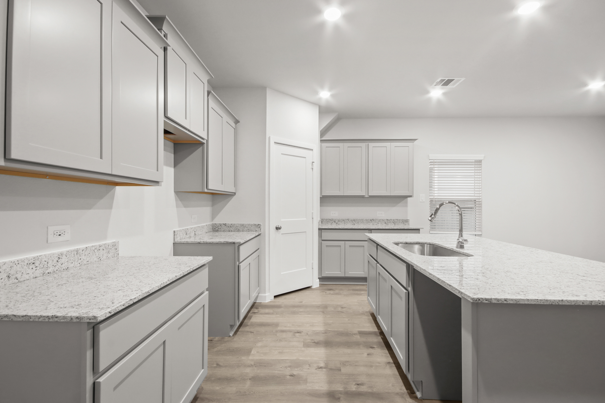 A kitchen with white cabinets.