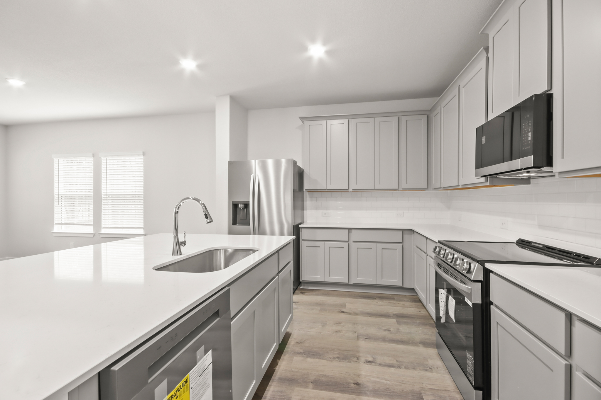 A kitchen with white cabinets.