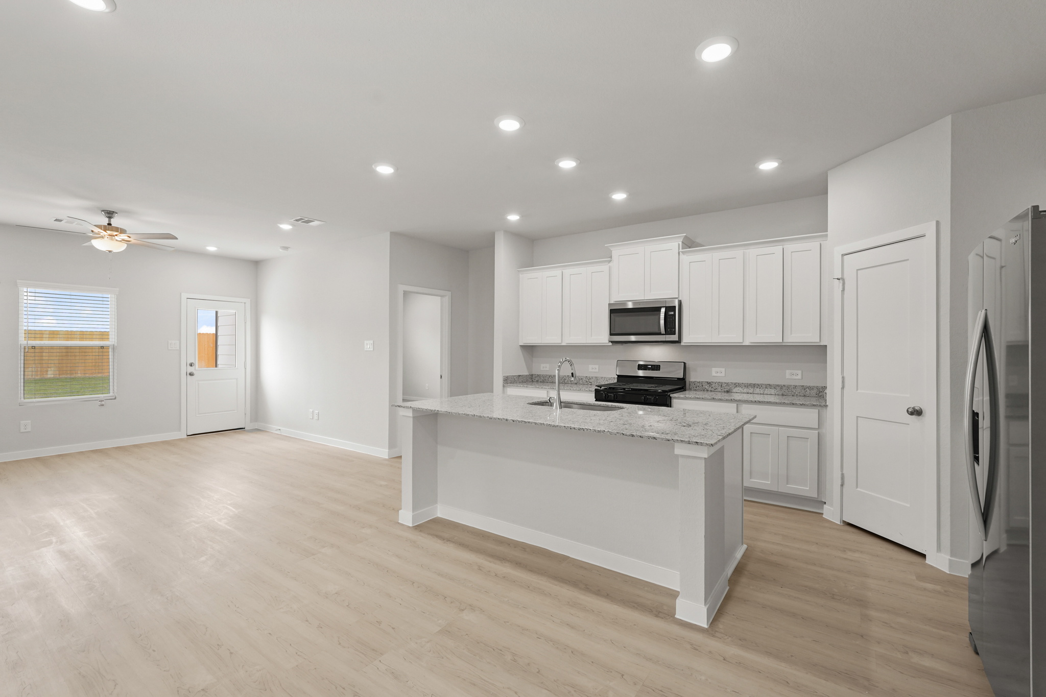 A kitchen with white cabinets.