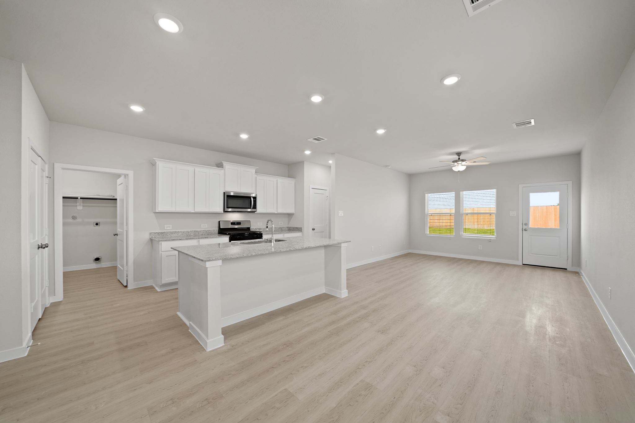 A large kitchen with white cabinets.