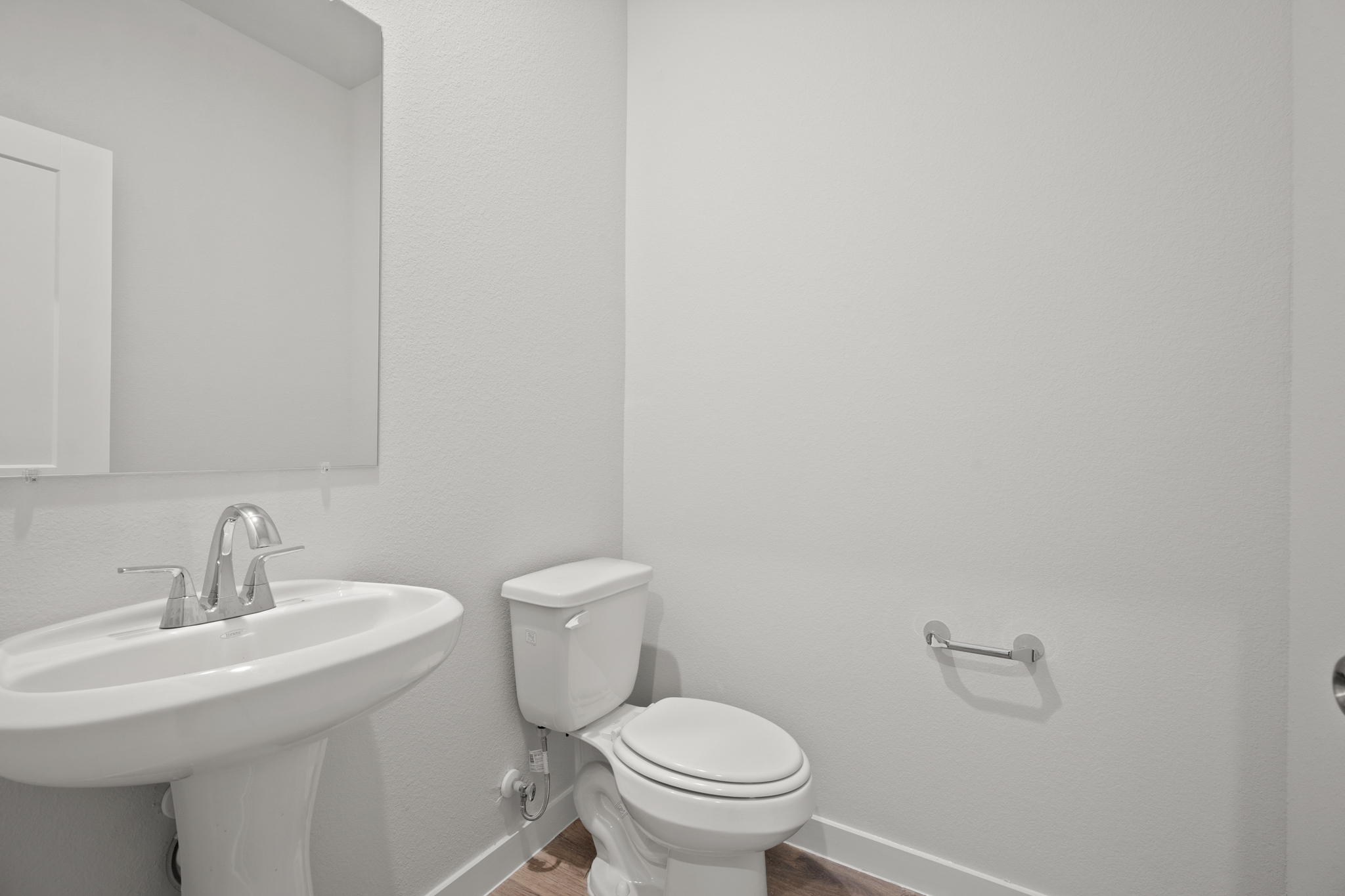 A bathroom with a toilet and sink.