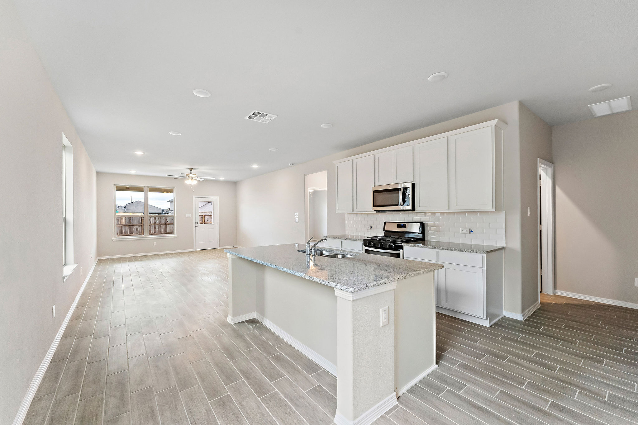 A kitchen with white cabinets.