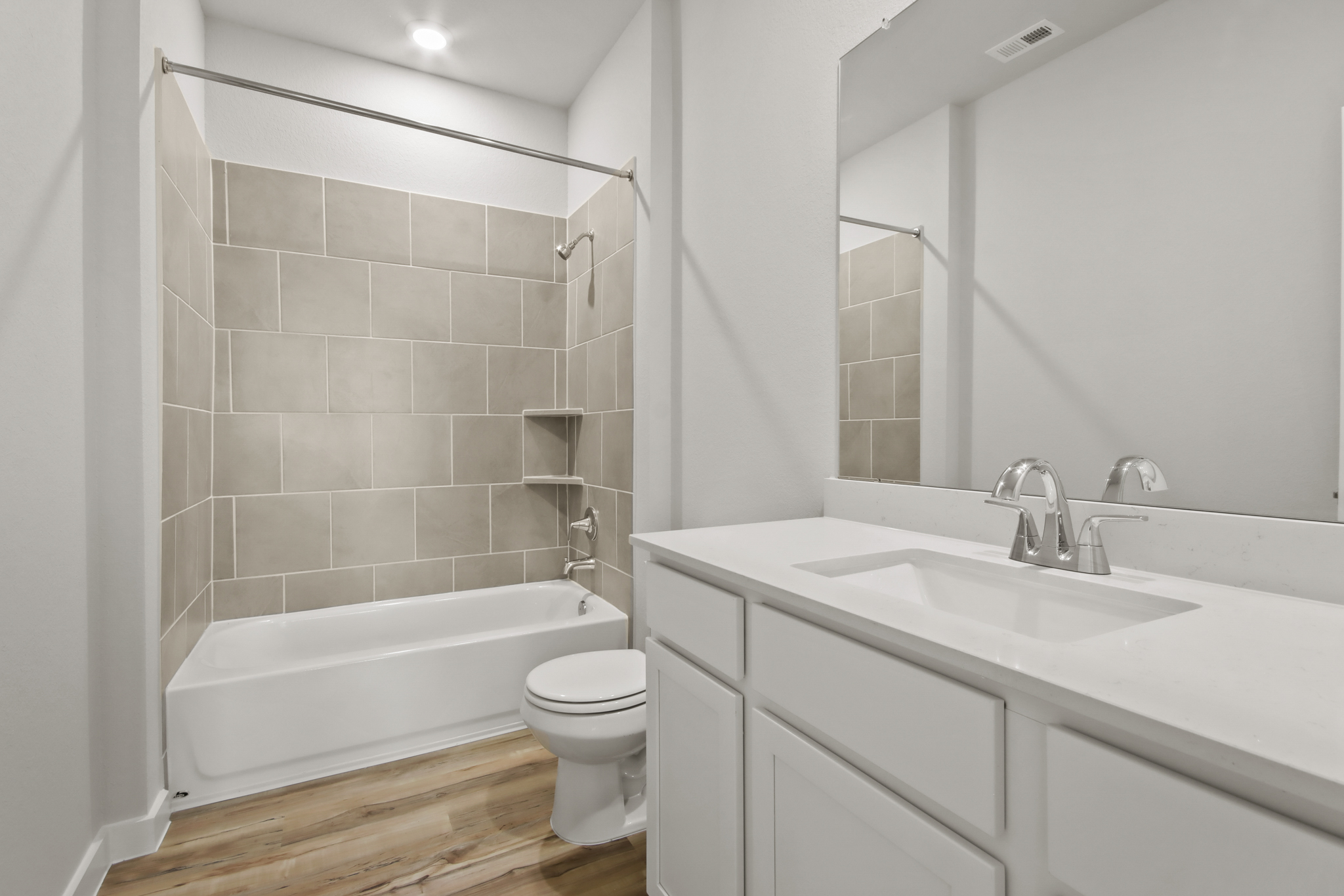 A bathroom with a tub sink and toilet.