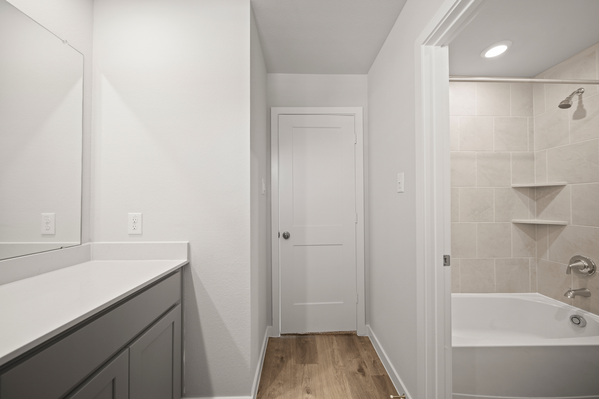 A bathroom with a tub and sink.