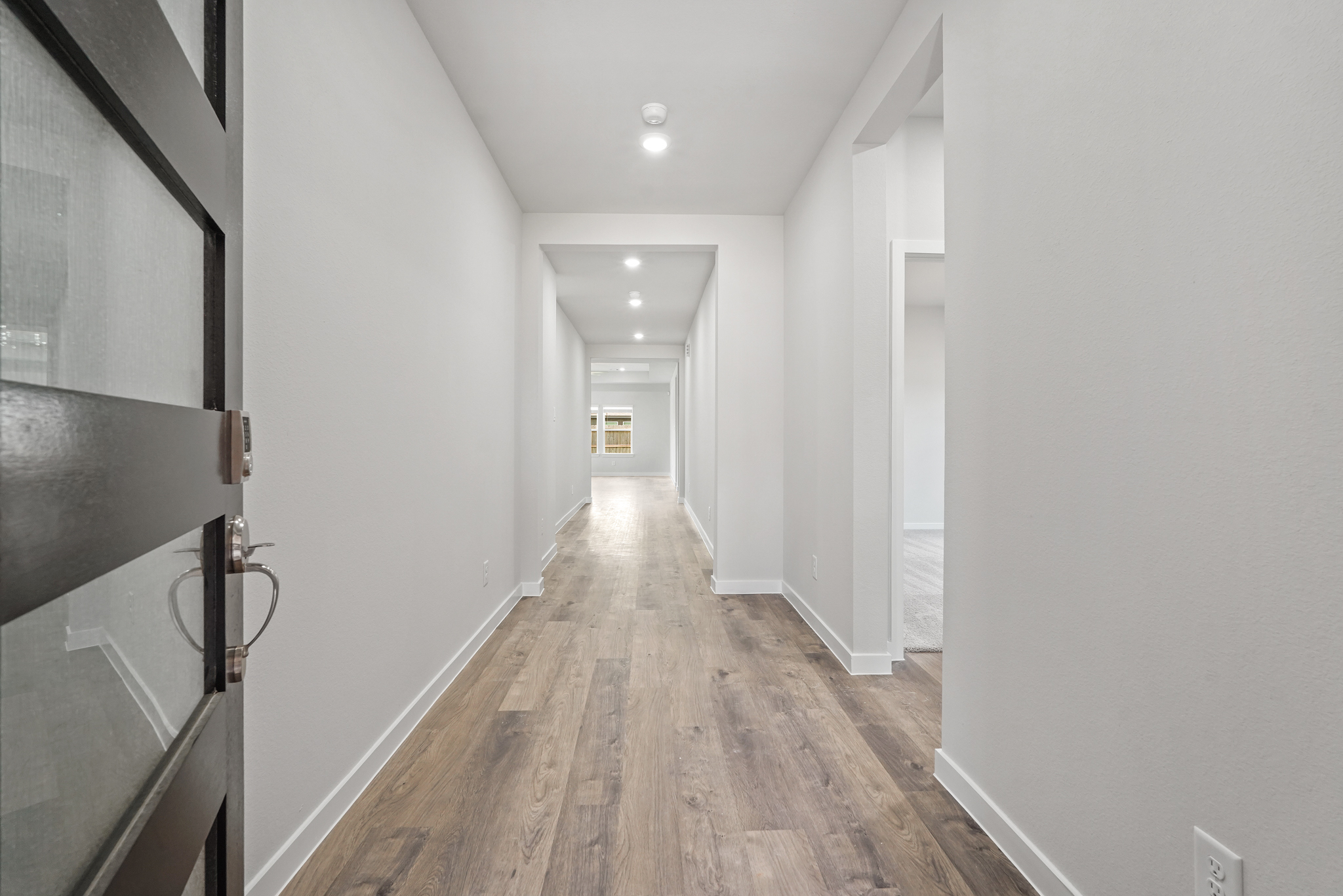 A long hallway with white walls.