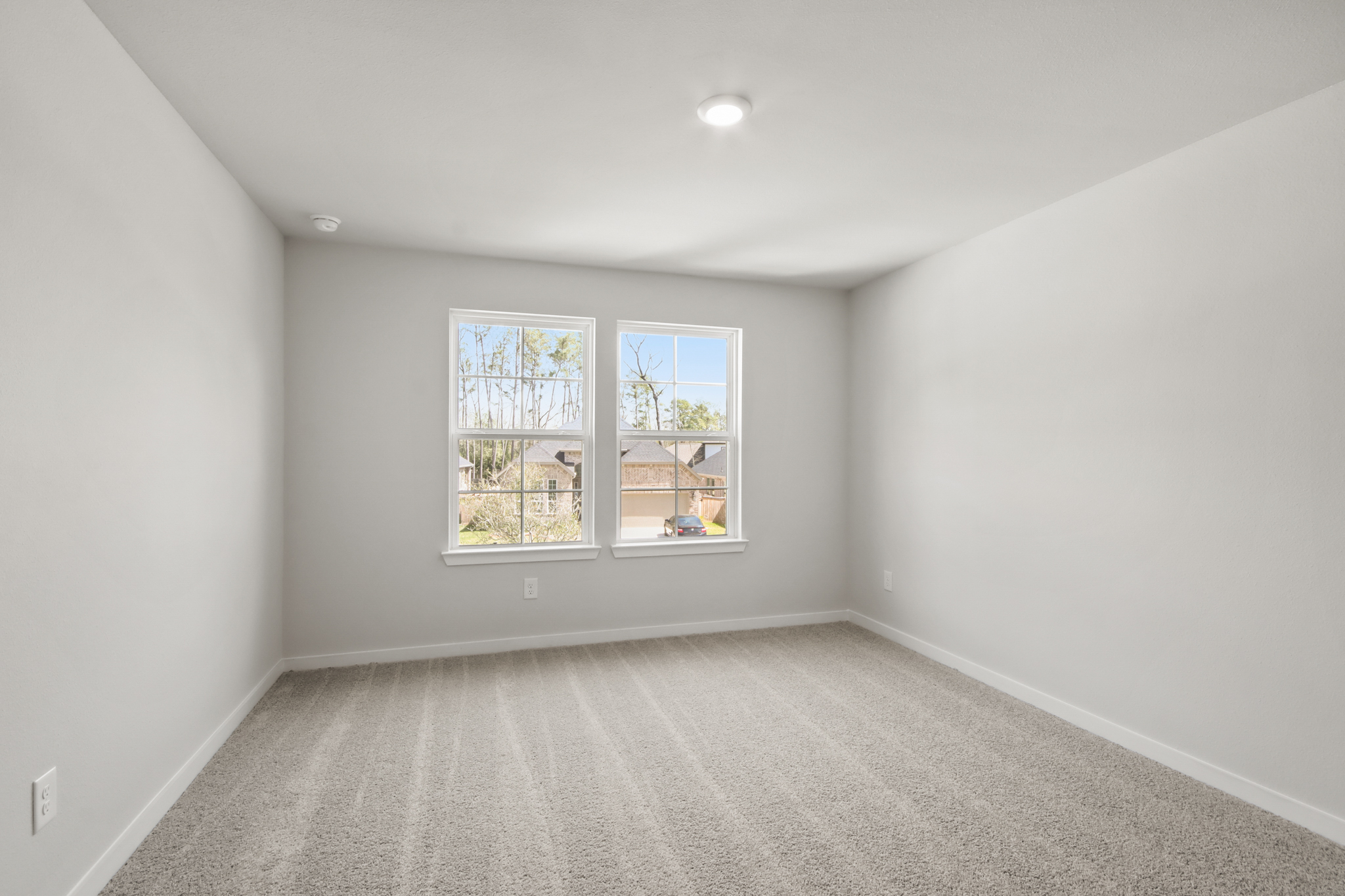 A room with a window and a carpet.