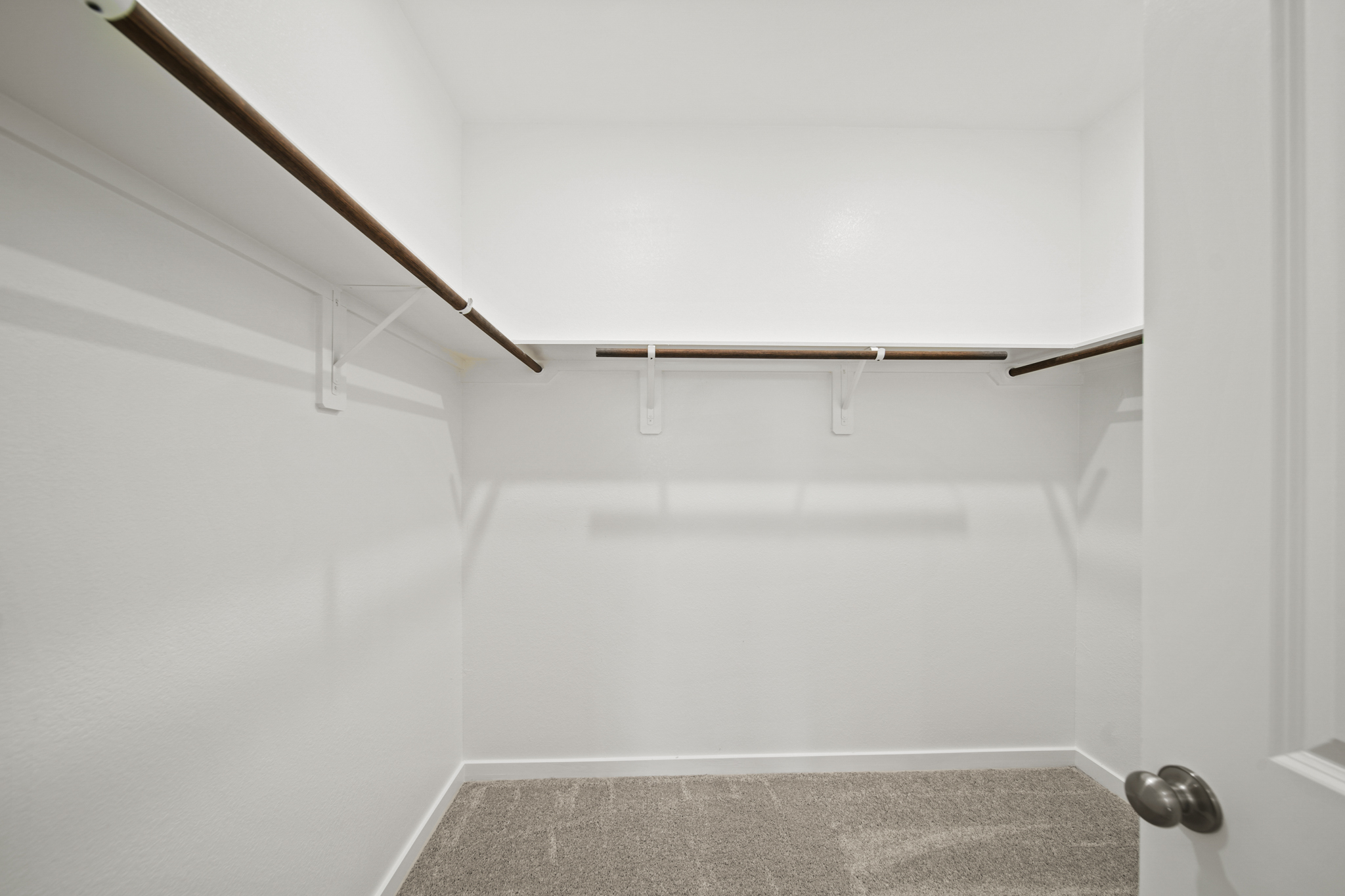 A white room with a metal railing.