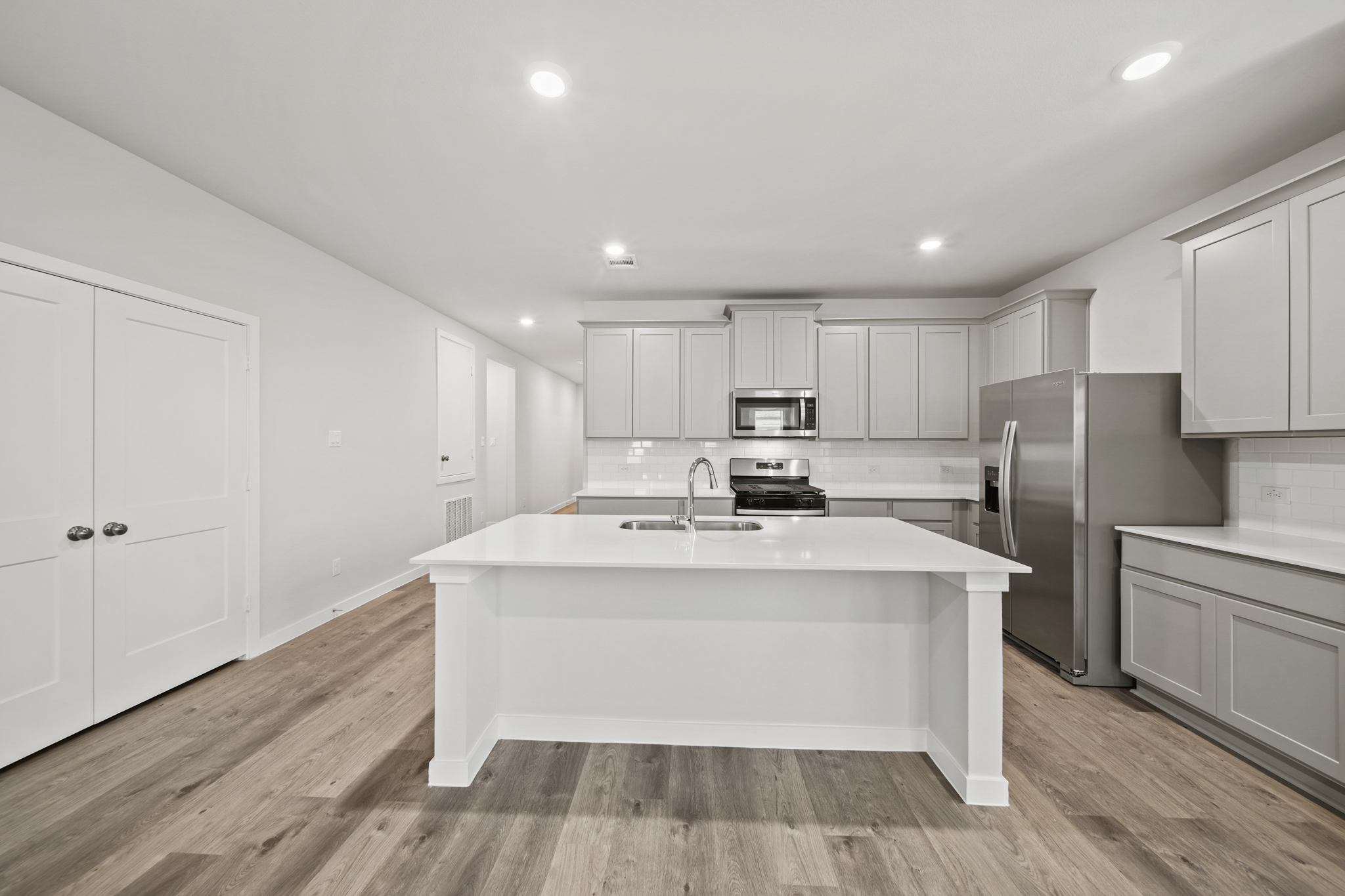 A kitchen with white cabinets.