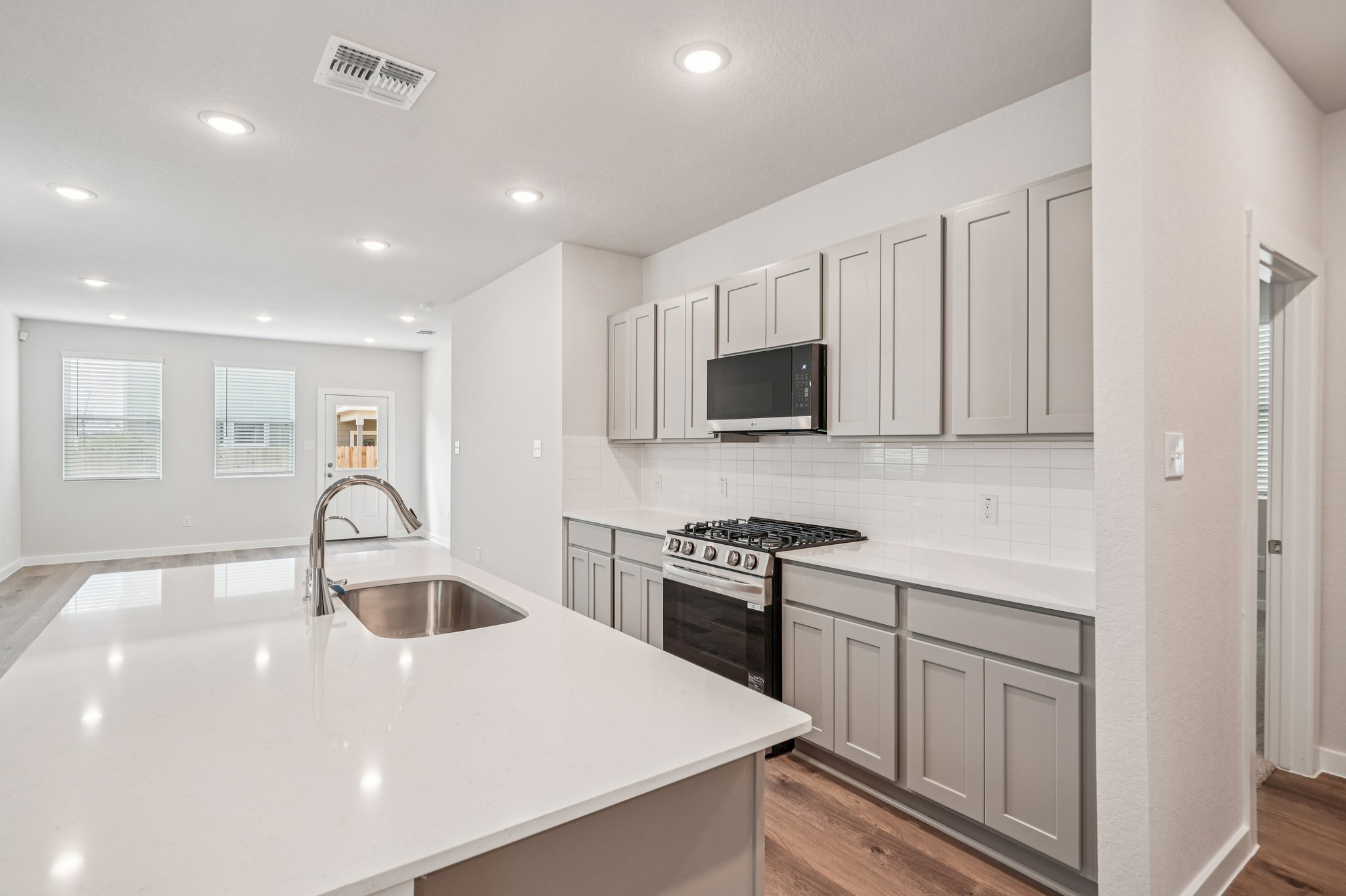 A kitchen with white cabinets.