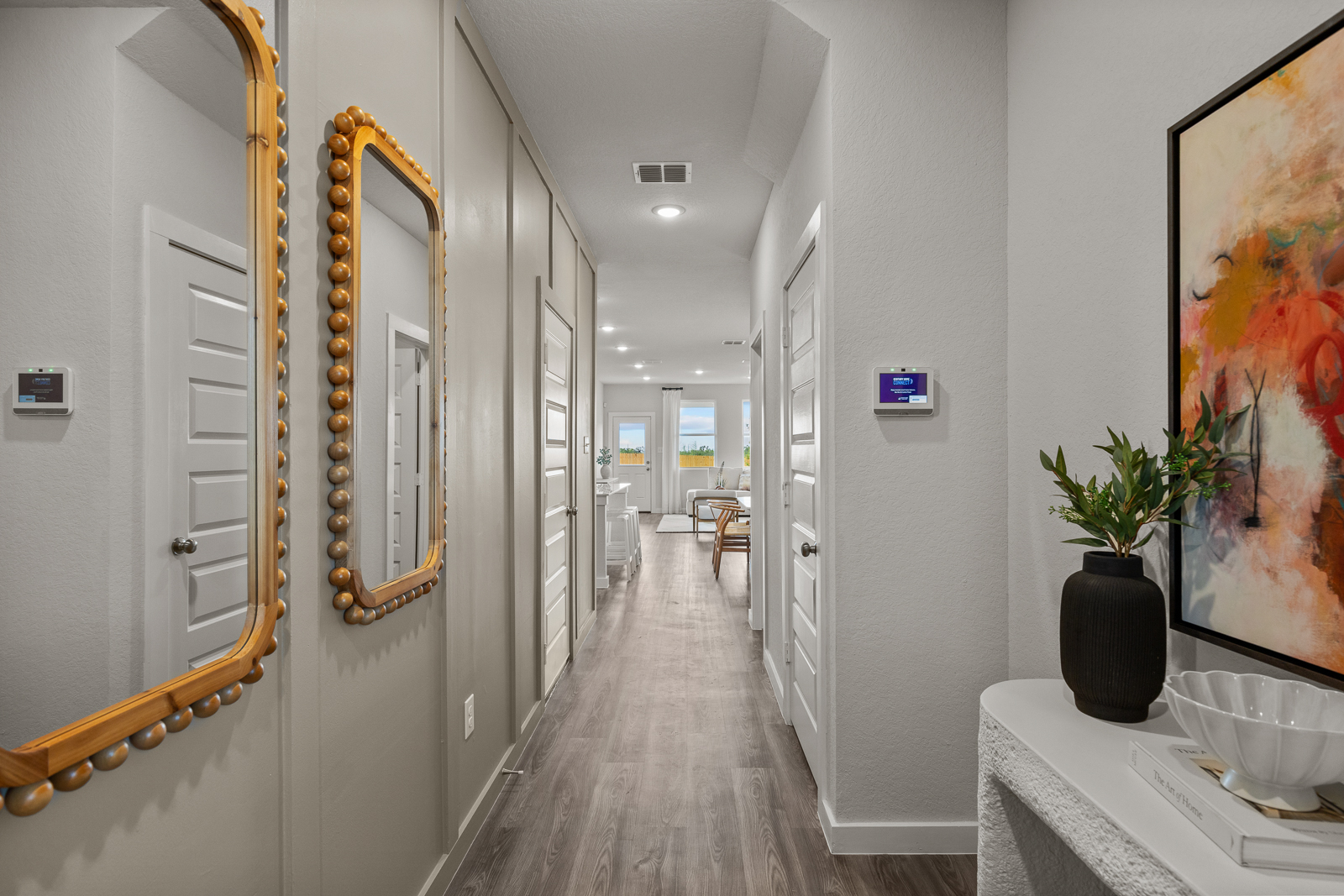 A hallway with a table and chairs.