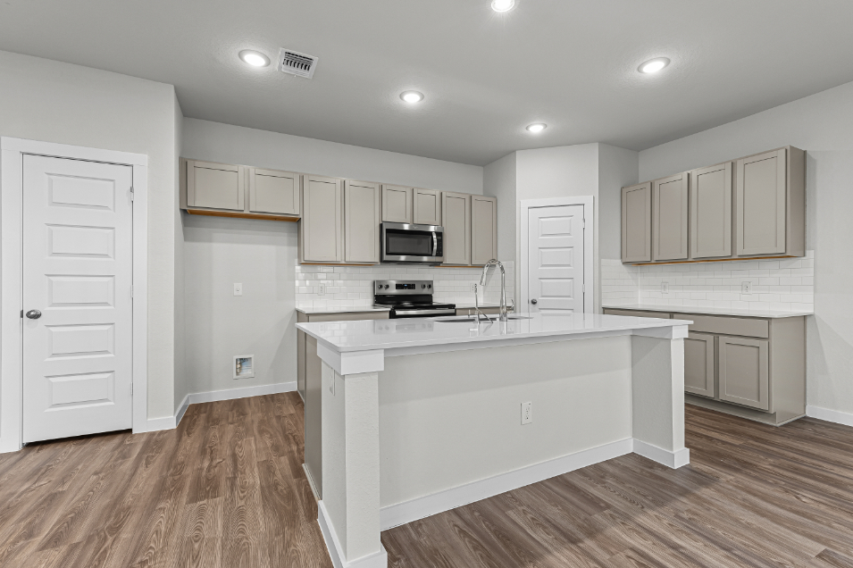 A kitchen with white cabinets.
