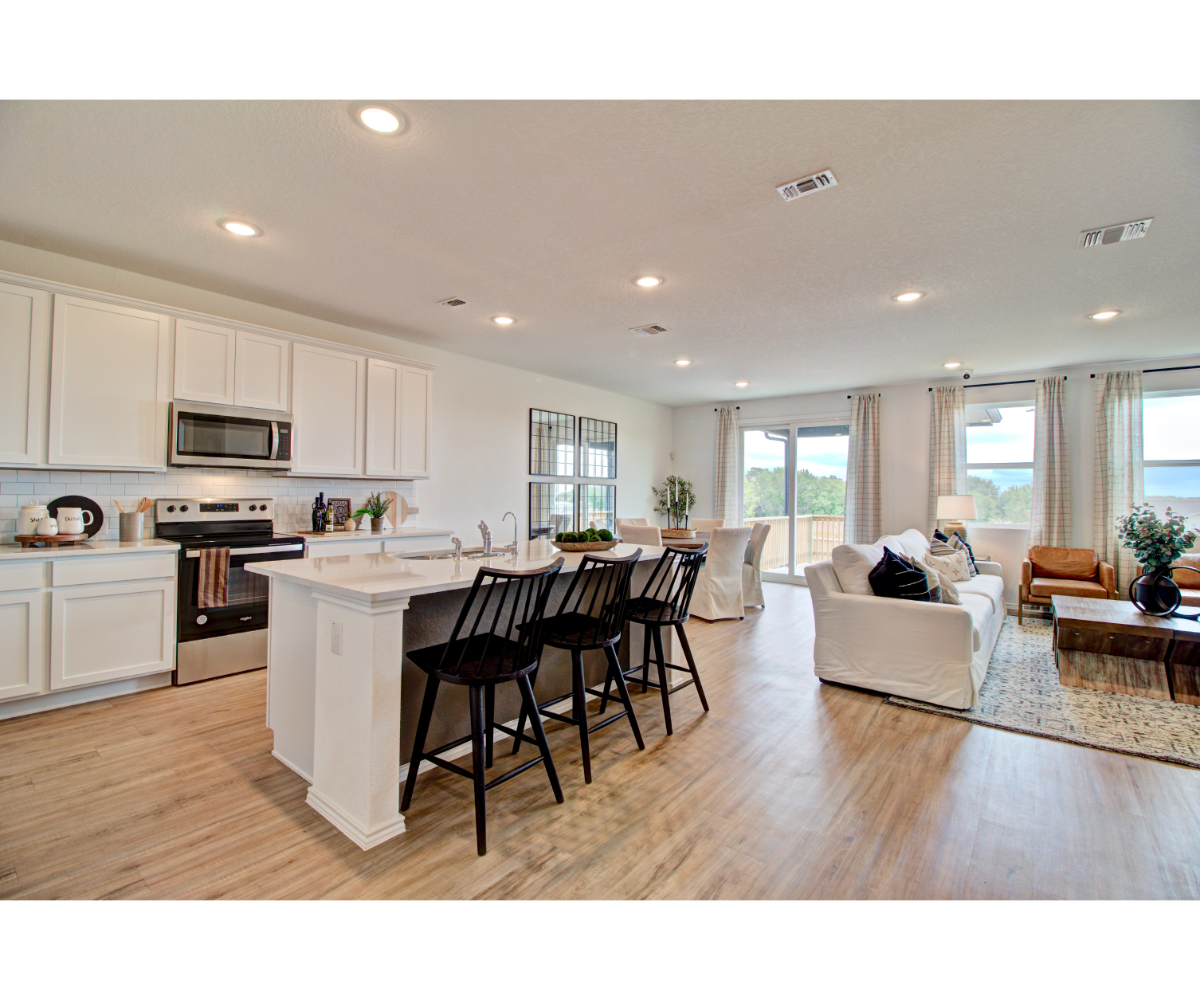 A large kitchen with a large dining table and a couch.
