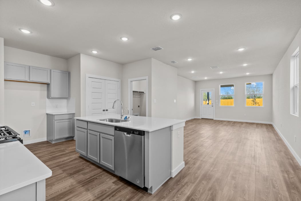 A kitchen with white cabinets.
