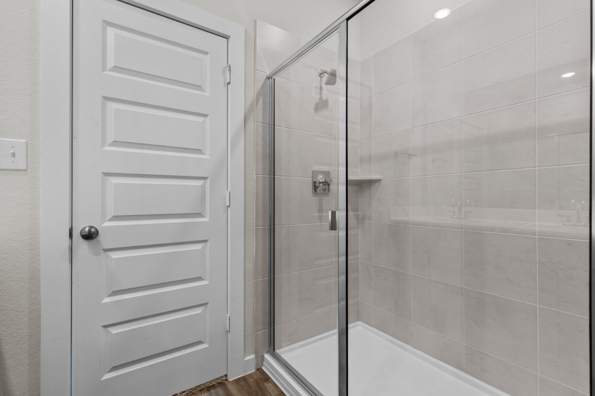 A shower with a glass door.