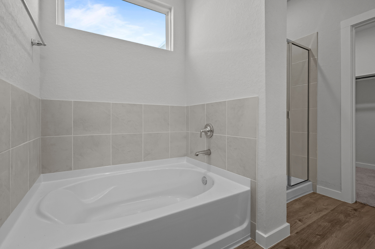 A bathtub in a bathroom.