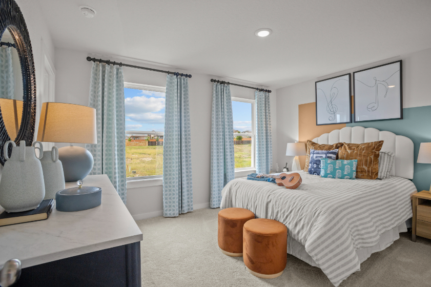 A bedroom with a bed and a desk.