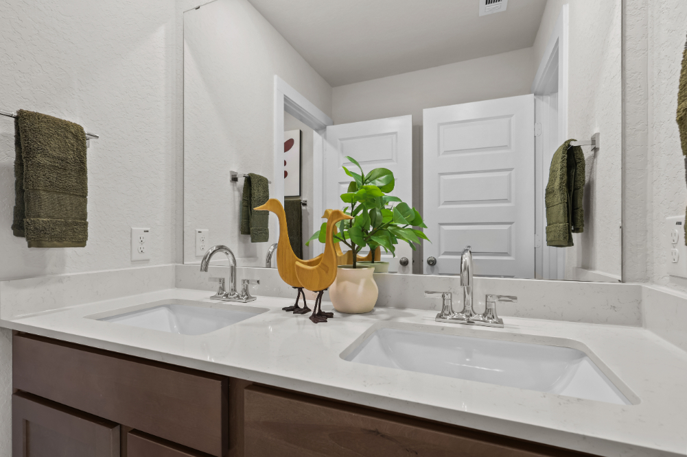 A bathroom with a sink and a mirror.
